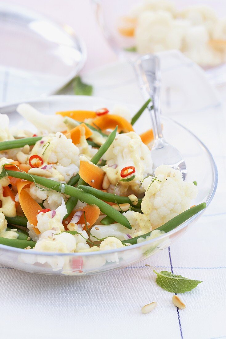Cauliflower, bean and carrot salad with pine nuts and chilli