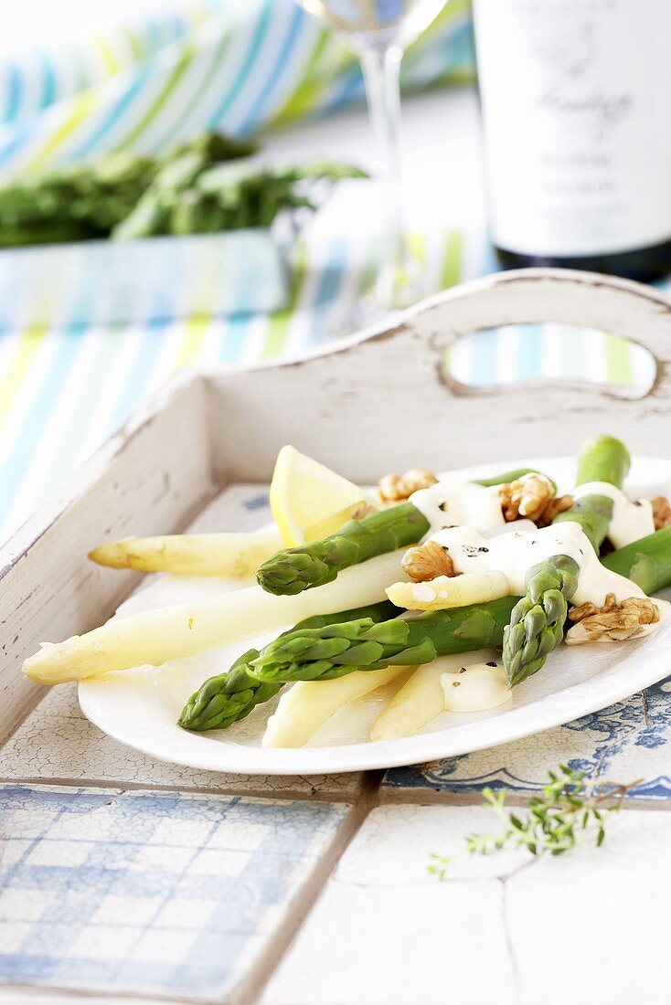 White and green asparagus with sour cream and walnuts