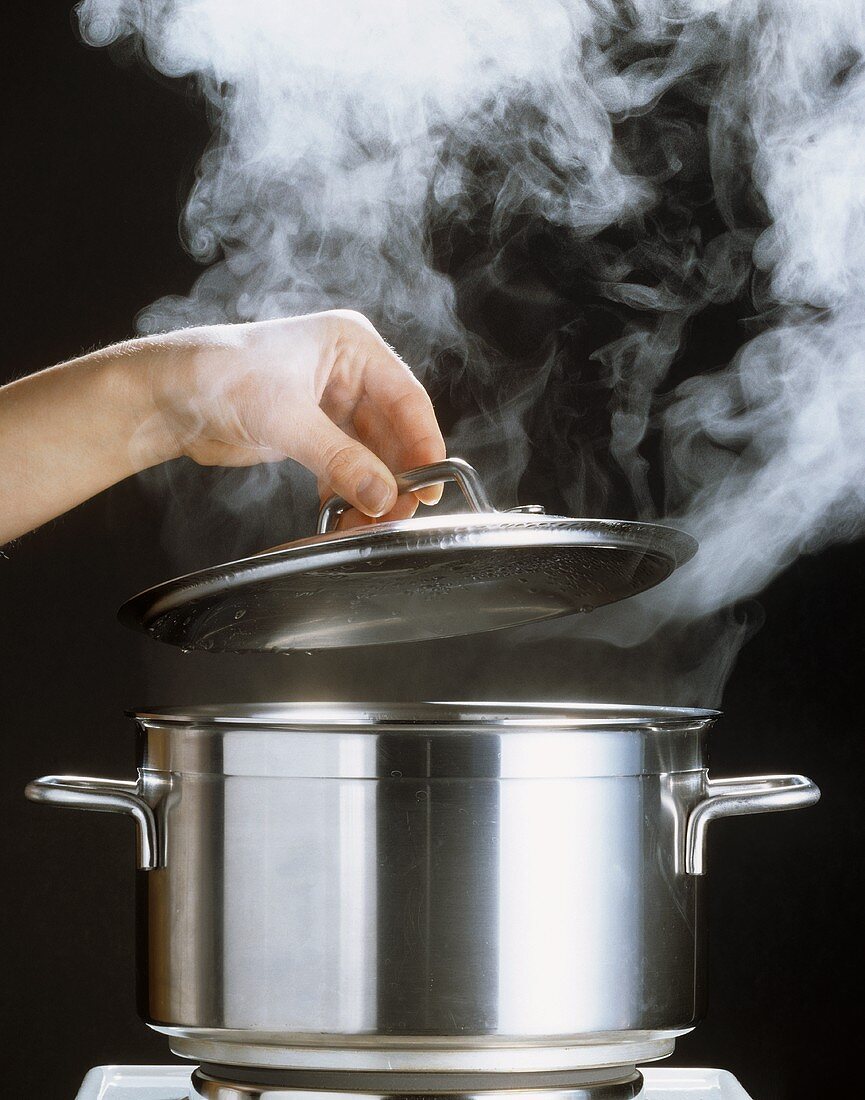 Hand Lifting Lid of Steaming Pot