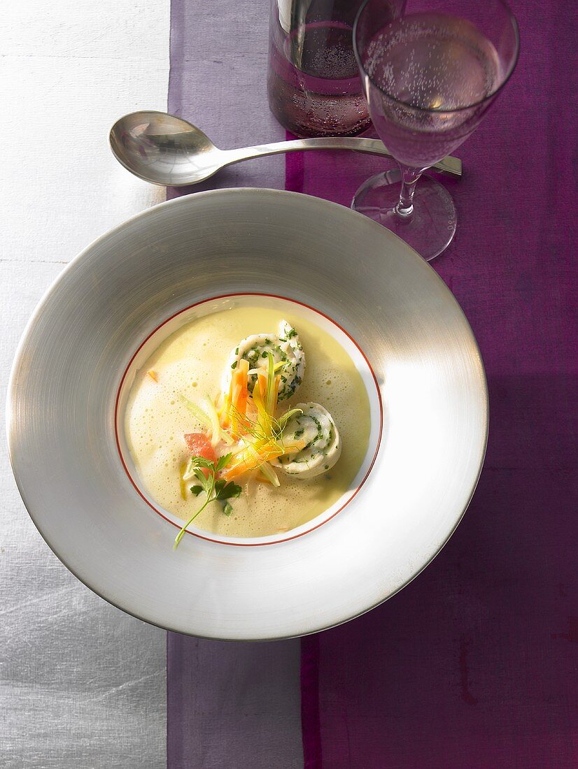 Vegetable soup with saffron and small turbot rolls