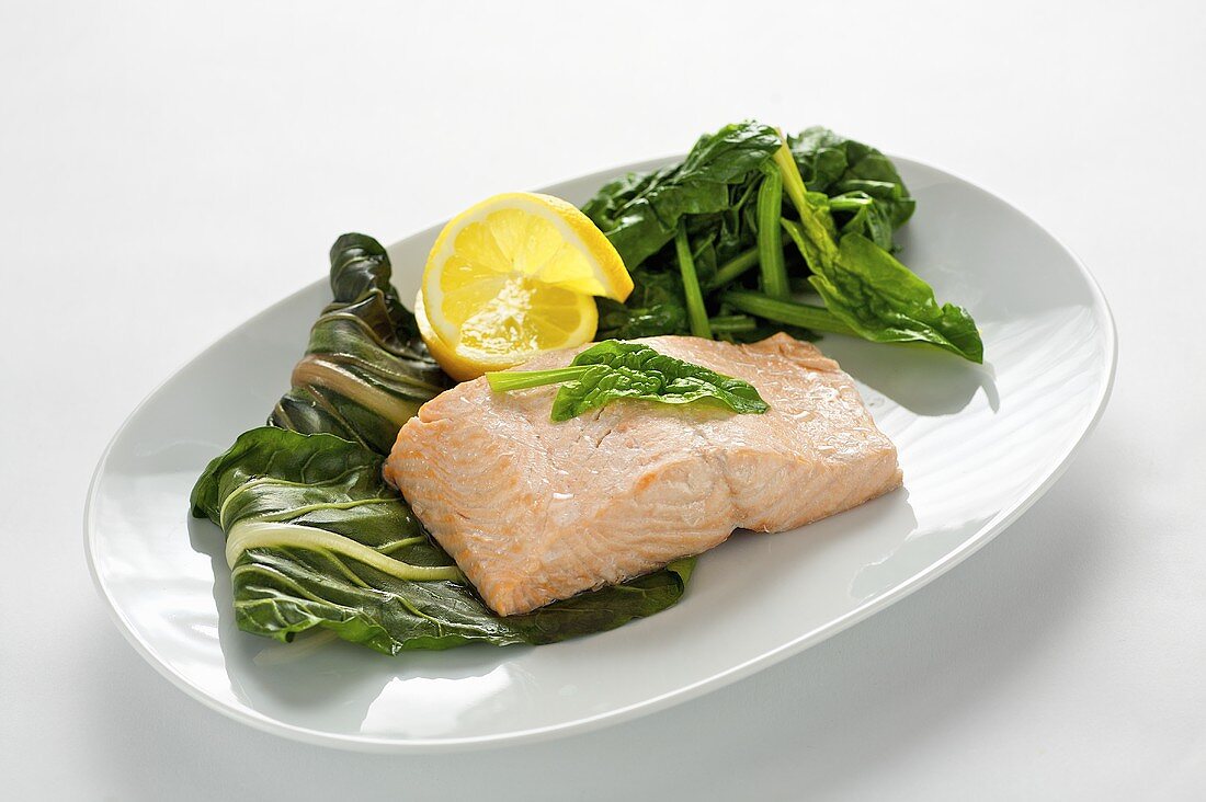 Steamed salmon steak with spinach and chard