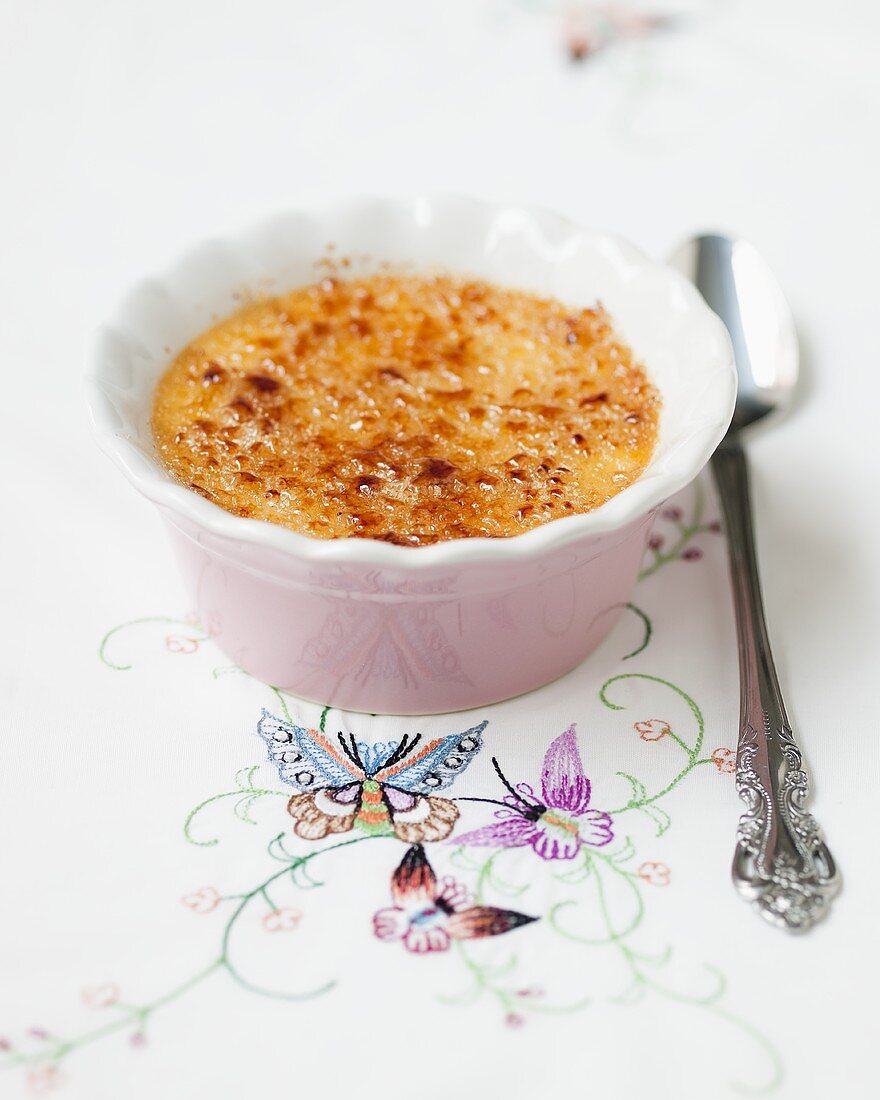 Crème brûlée on embroidered tablecloth