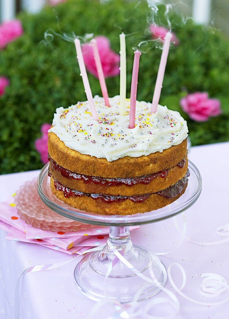 Filled birthday cake with five candles