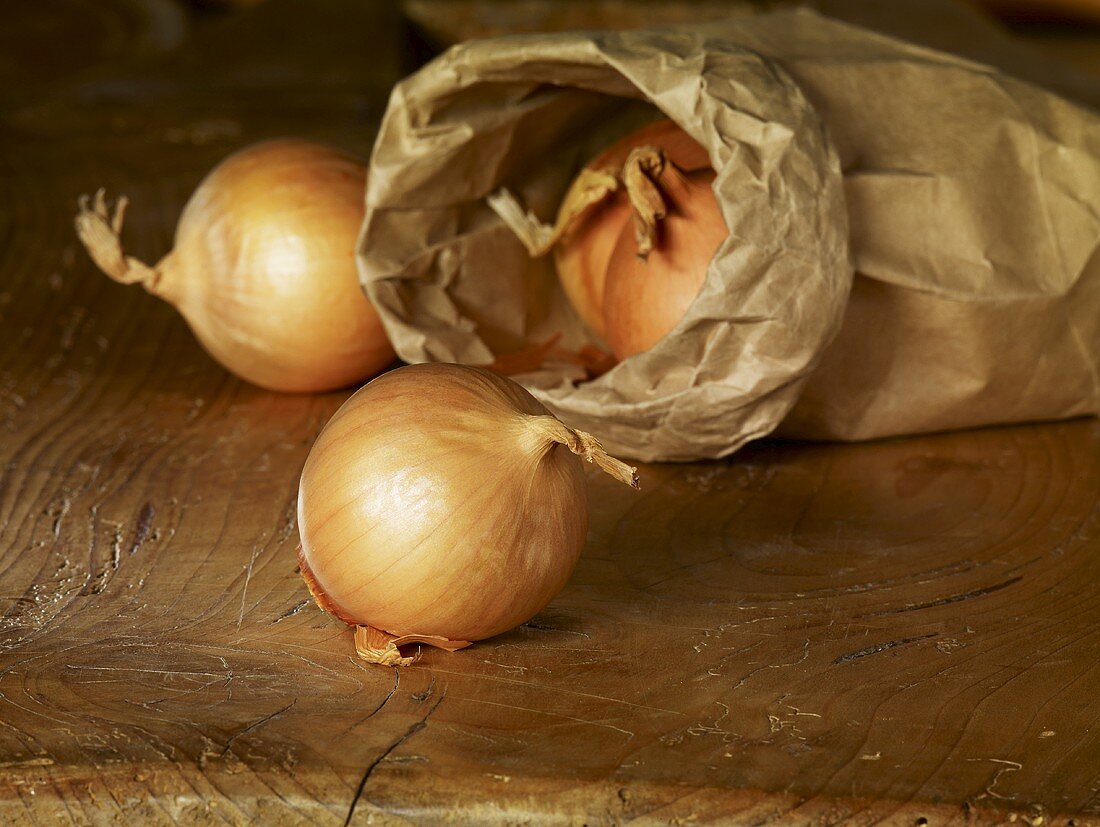 Yellow onions with paper bag
