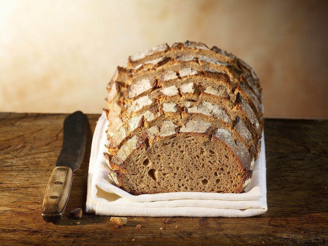 Crusty bread, sliced, on linen cloth