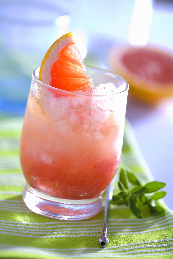 Grapefruit drink with ice cubes