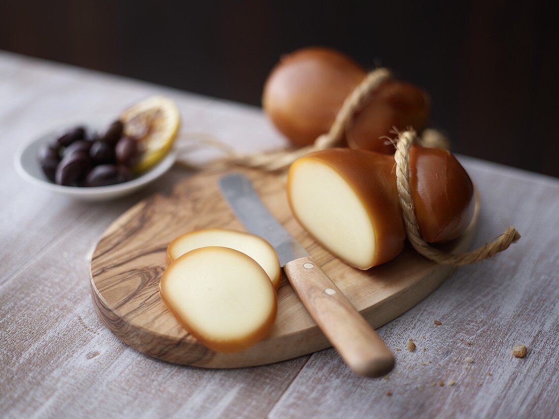 Partly sliced Scamorza with olives