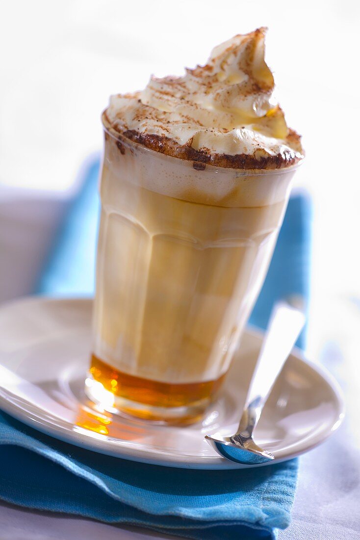 A glass of caffe latte caramel with whipped cream