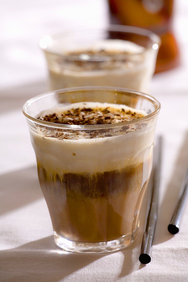 Two glasses of espresso with chocolate-nut liqueur and cream
