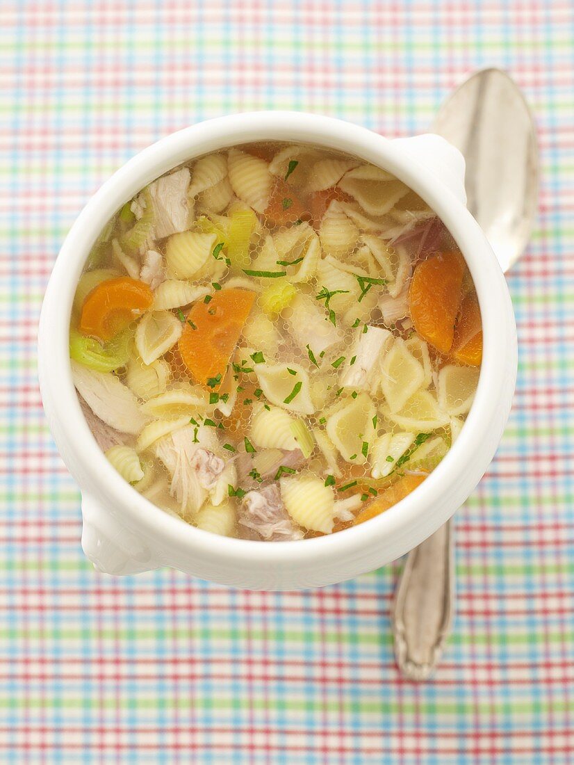 Chicken soup with pasta and carrots (overhead view)