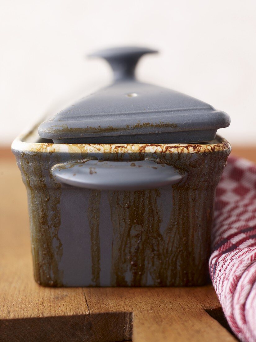 Terrine dish with burnt-on food