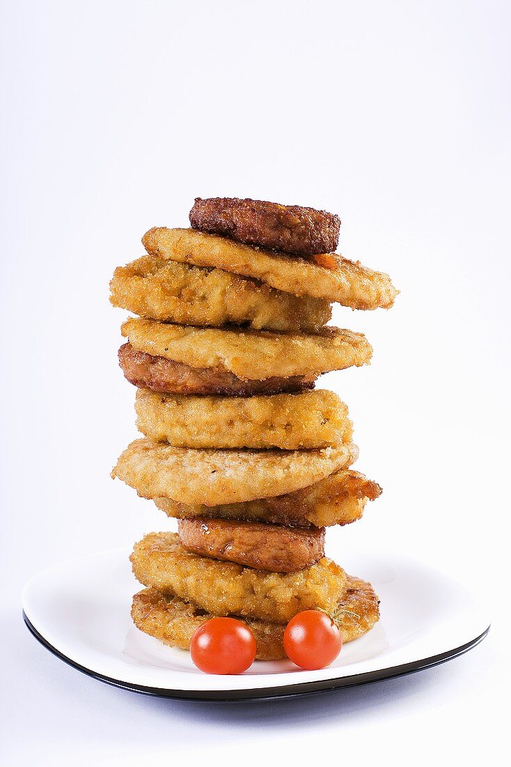 Breaded meat and burgers, stacked