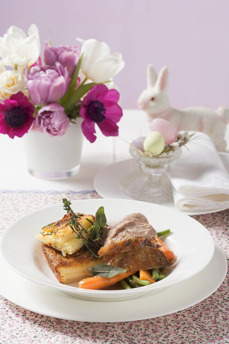 Roast lamb with potato gratin and vegetables for Easter