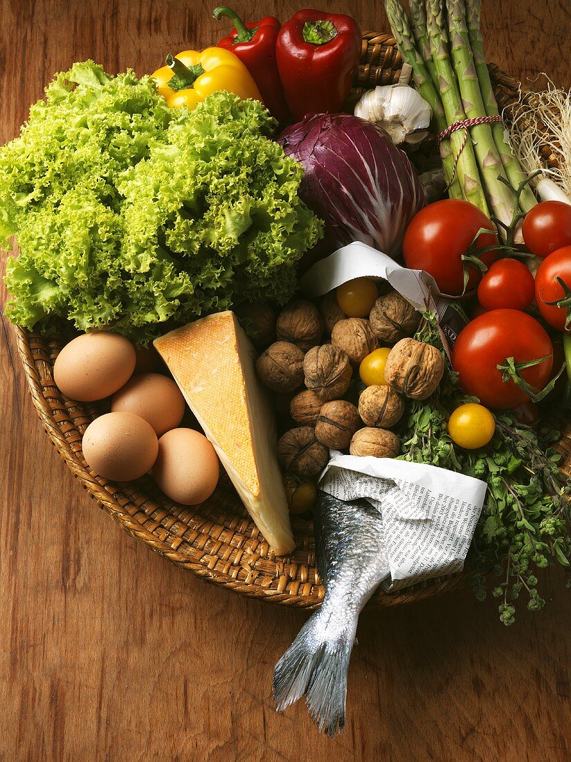Vegetables, eggs, cheese and nuts in basket