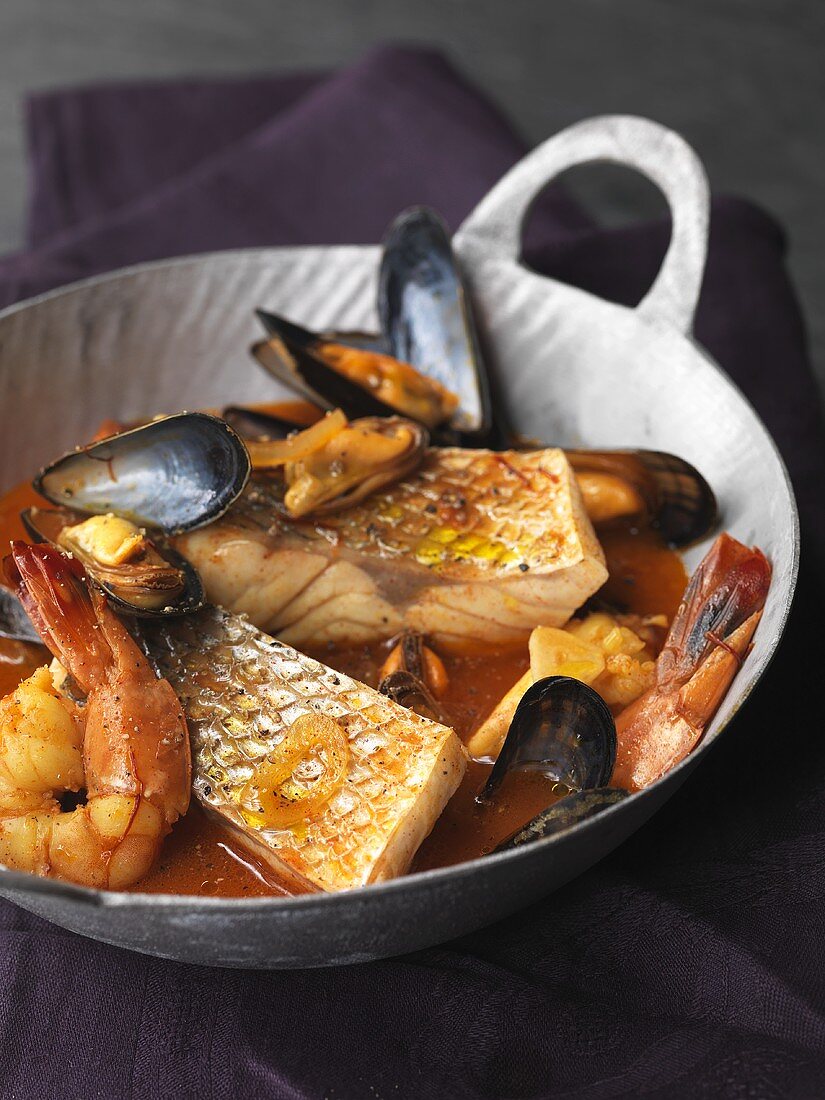 Sea bass with mussels and prawns in pepper and saffron broth
