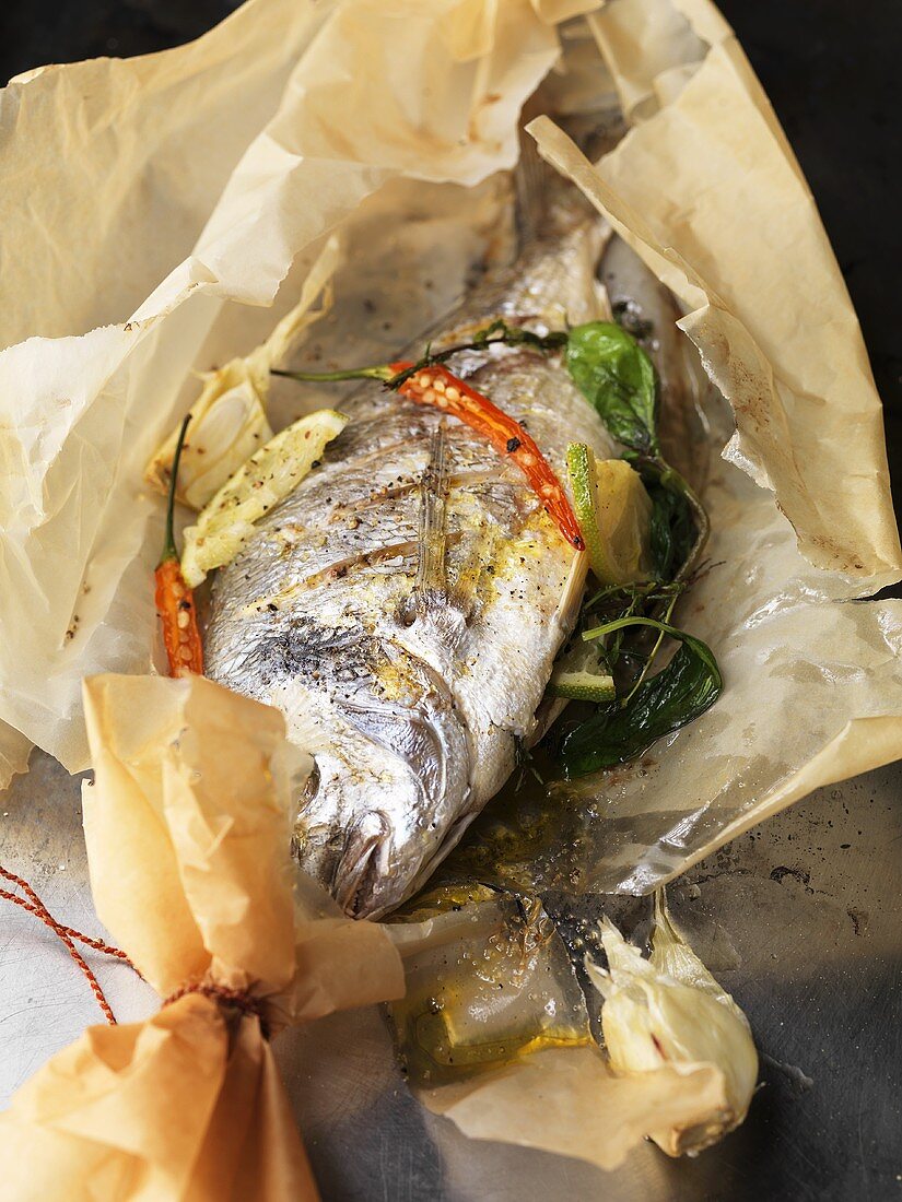Sea bream with basil and lime cooked en papillote