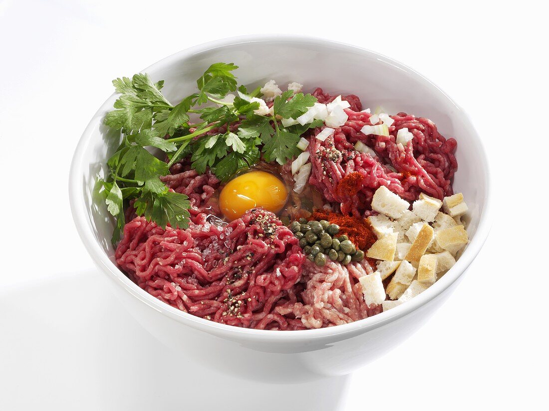 Ingredients for burgers made with minced beef and pork
