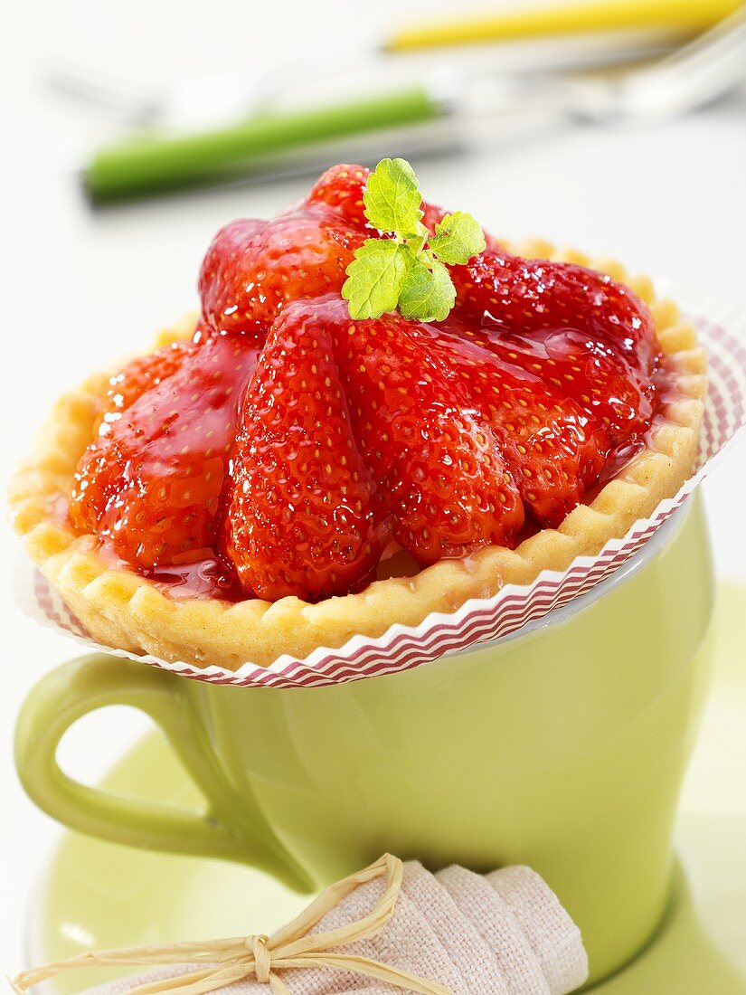 Strawberry tart on coffee cup