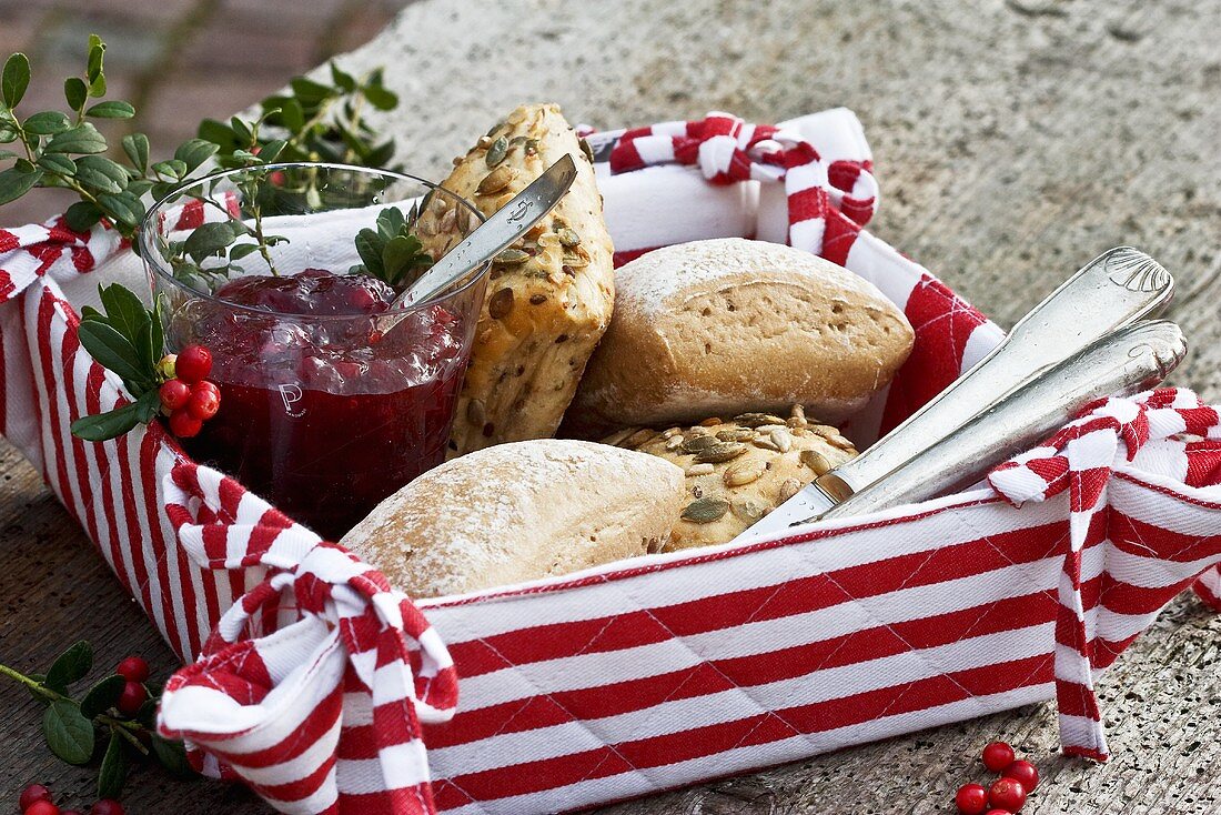 Bread rolls and cranberry jam in a basket