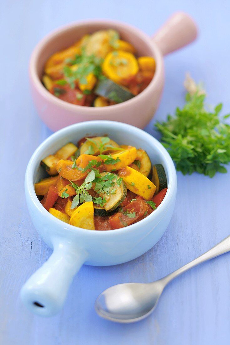 Two bowls of ratatouille with fresh herbs