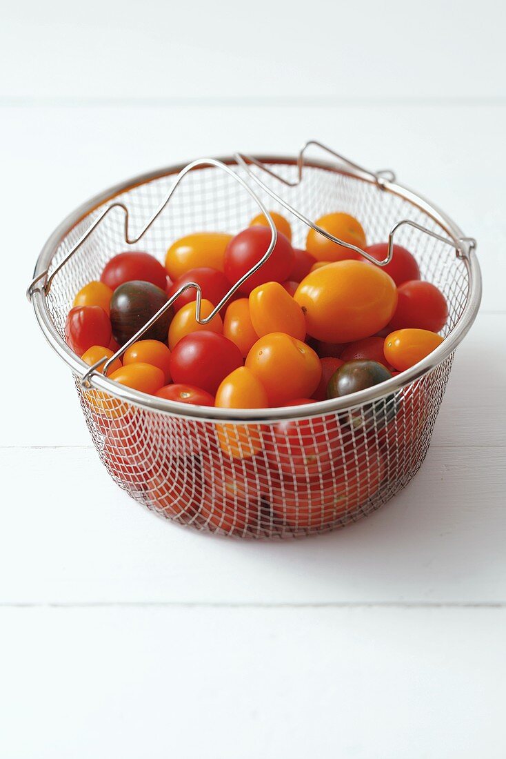 Various types of tomatoes in a steaming basket