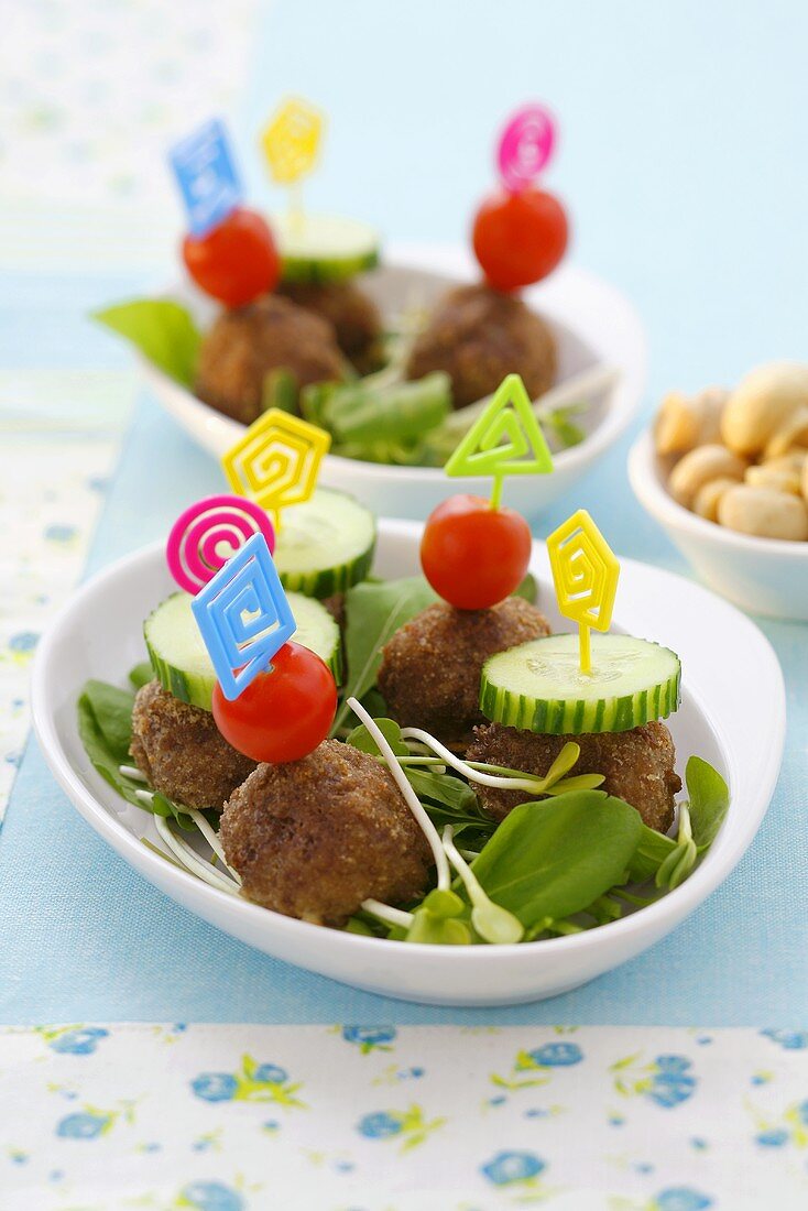 Meatballs with tomatoes and cucumber on cocktail sticks