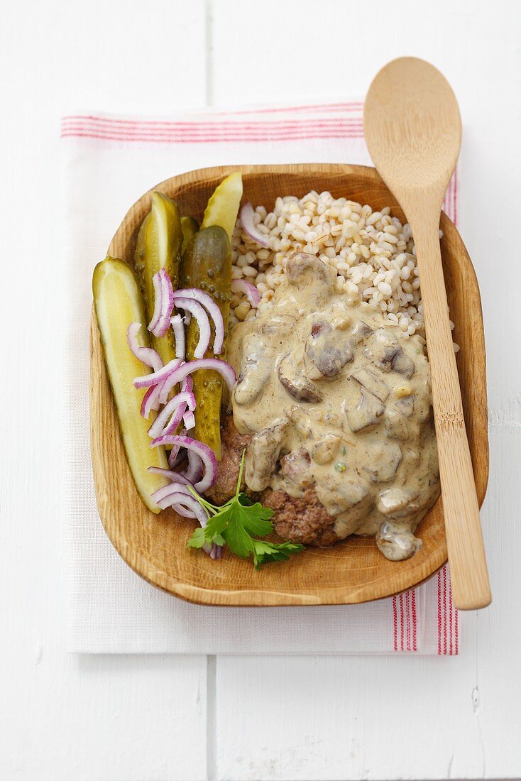 Mince with mushroom sauce and pickled gherkins on barley