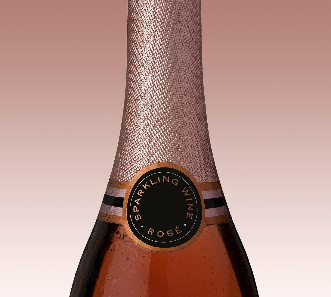 Rosé sparkling wine in bottle (detail)