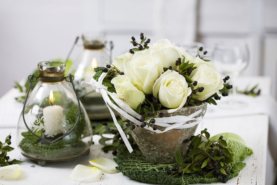 Arrangement of white roses and myrtle in resin pot