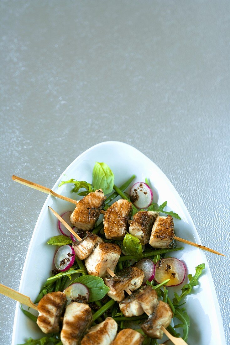 Tilapia kebabs on salad