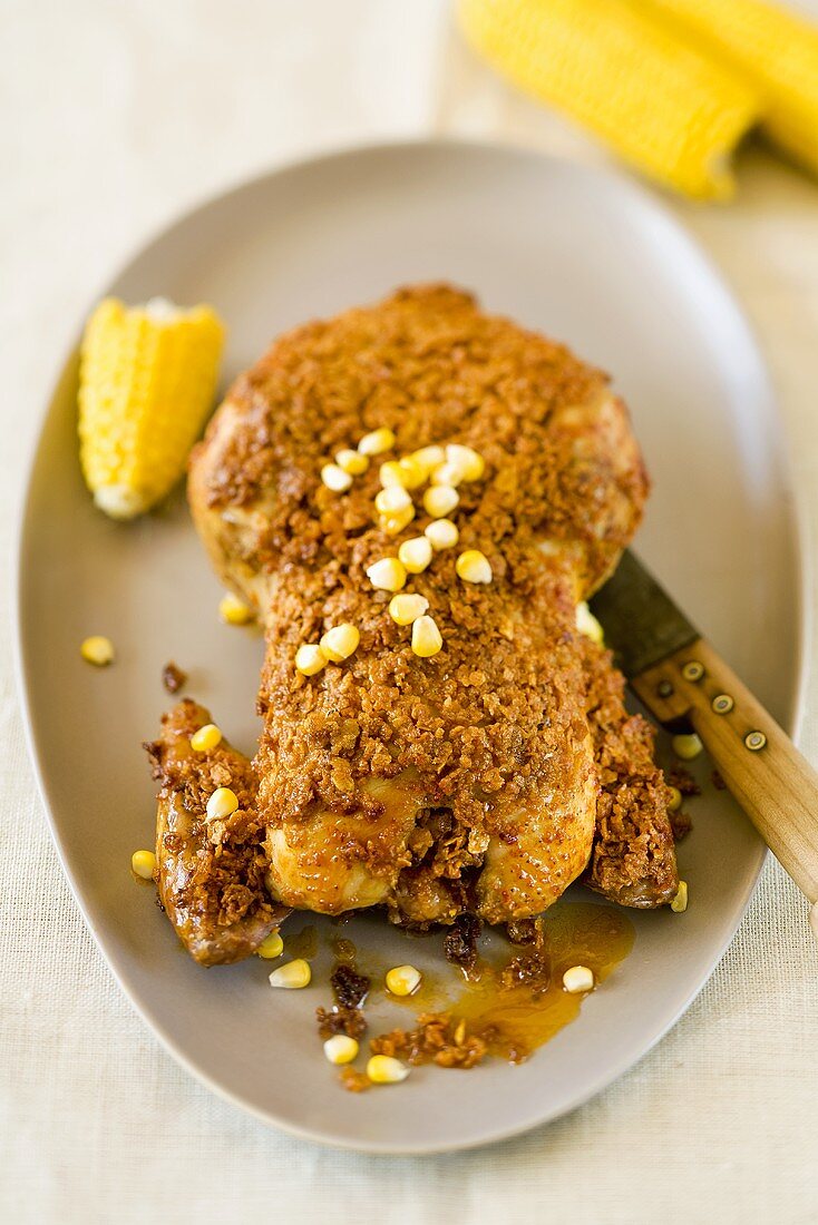 Chicken with spicy crust and corn on the cob