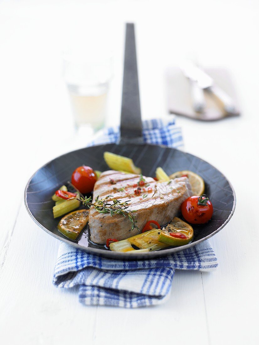 Tuna fillet with vegetables in frying pan