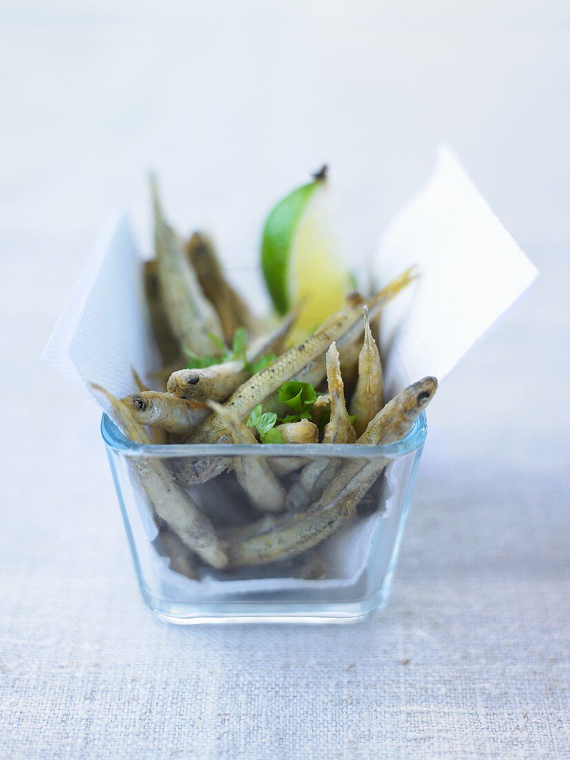 Anchovies with lime in glass dish