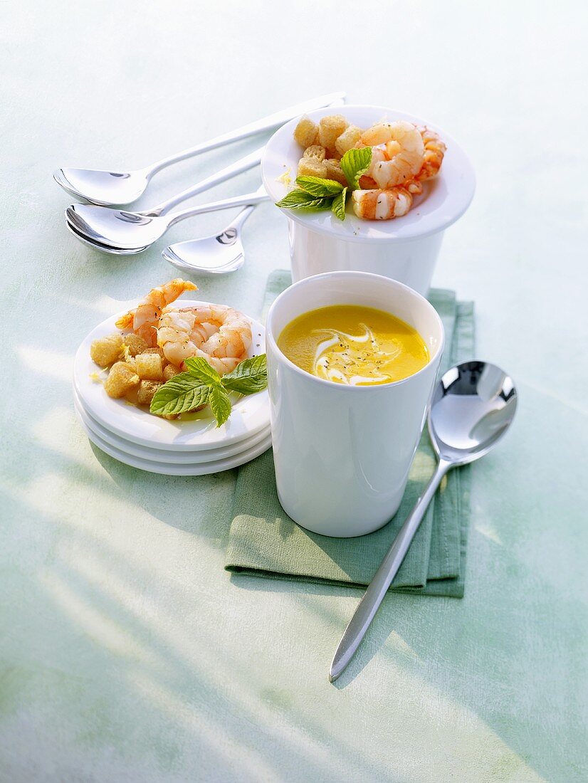 Orange and carrot soup with shrimps