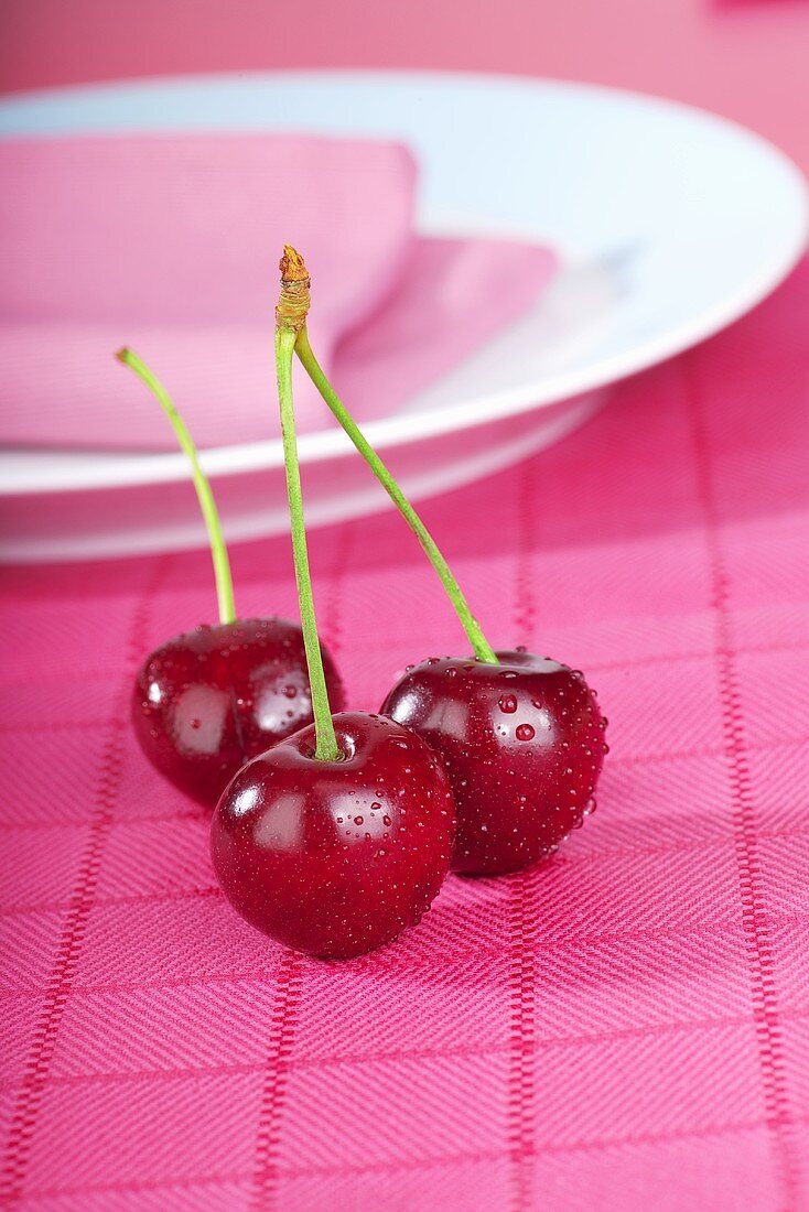 Cherries on pink tea towel