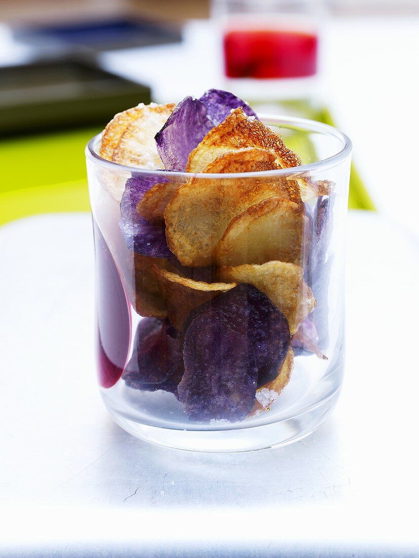 Home-made potato crisps in a glass