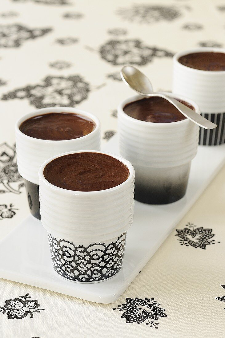 Chocolate cream in four beakers