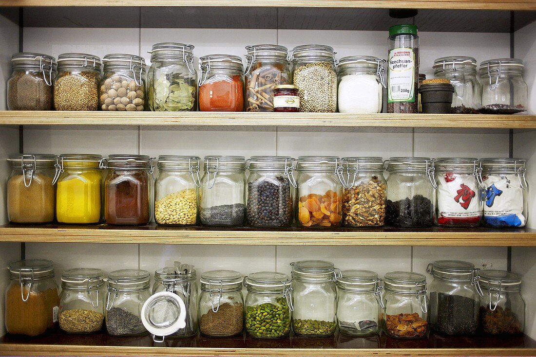 Spices in preserving jars on shelves