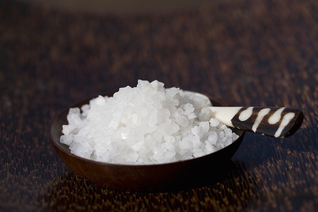 Sea salt in a small wooden dish with spoon