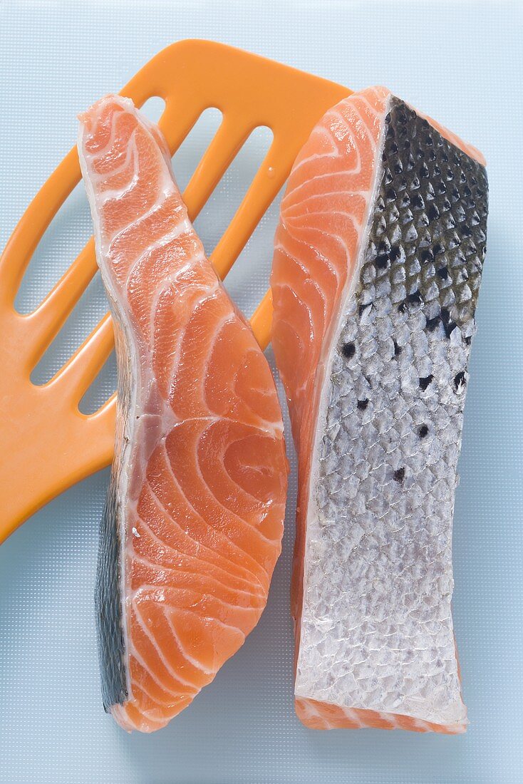 Pieces of raw salmon with orange spatula