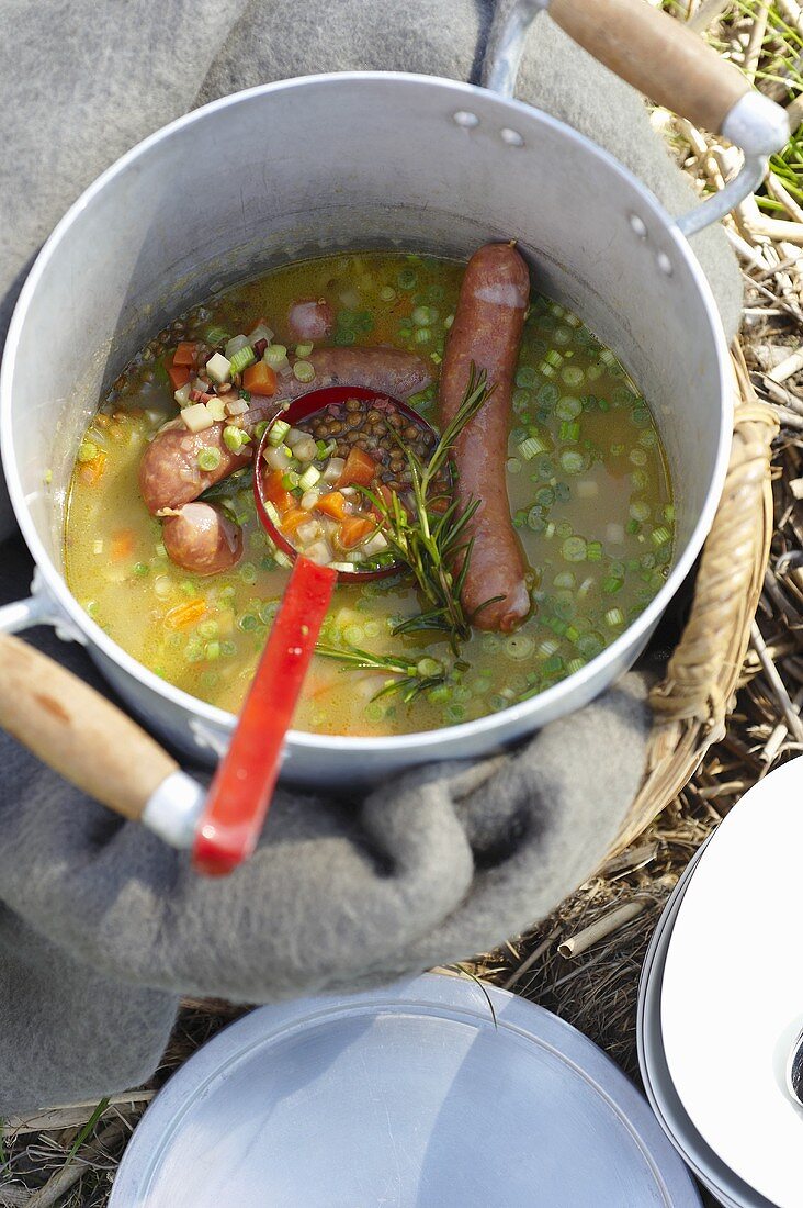 A pan of lentil and sausage stew for a picnic