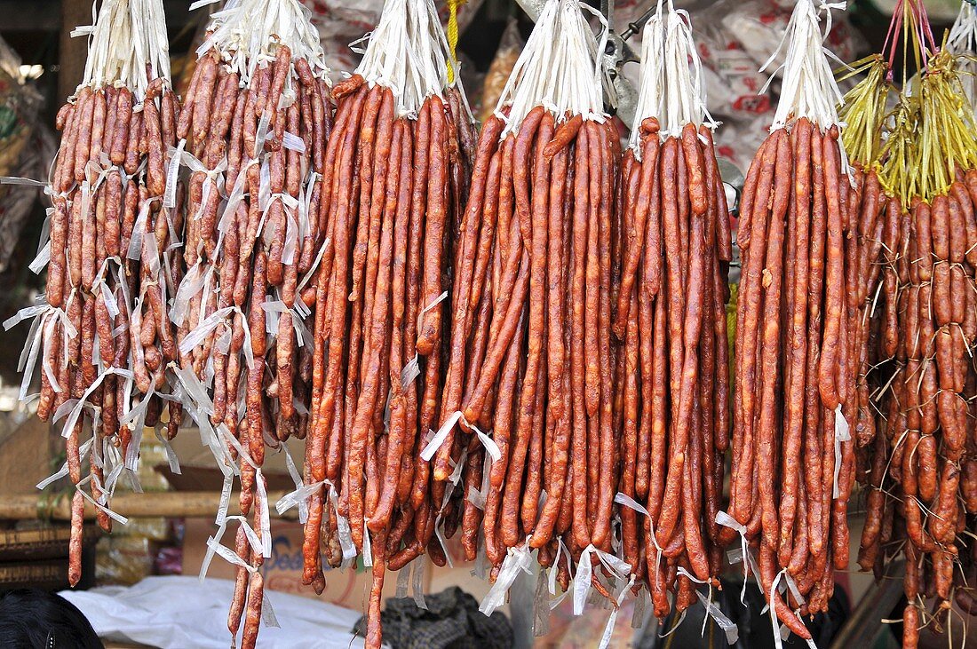Sausages hanging on a market stall in Burma