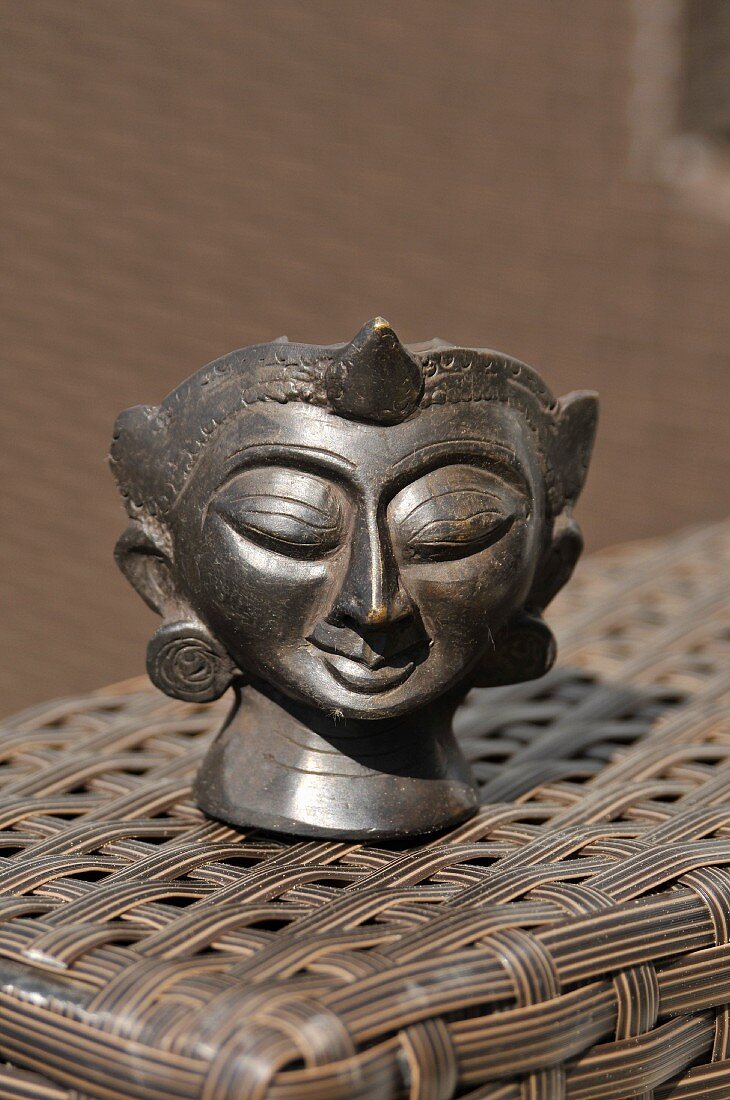 Bronze head from Burma being used as an ashtray
