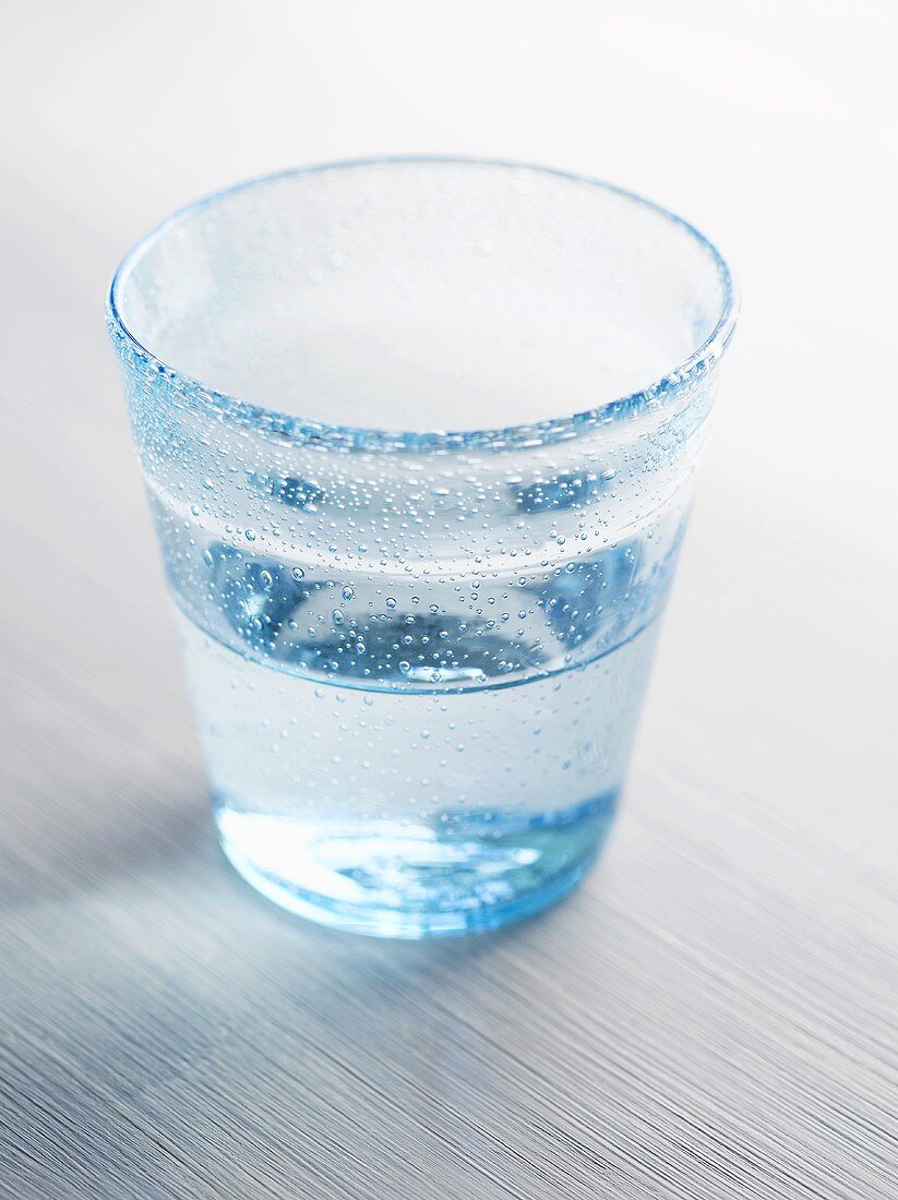 Pale blue glass of water