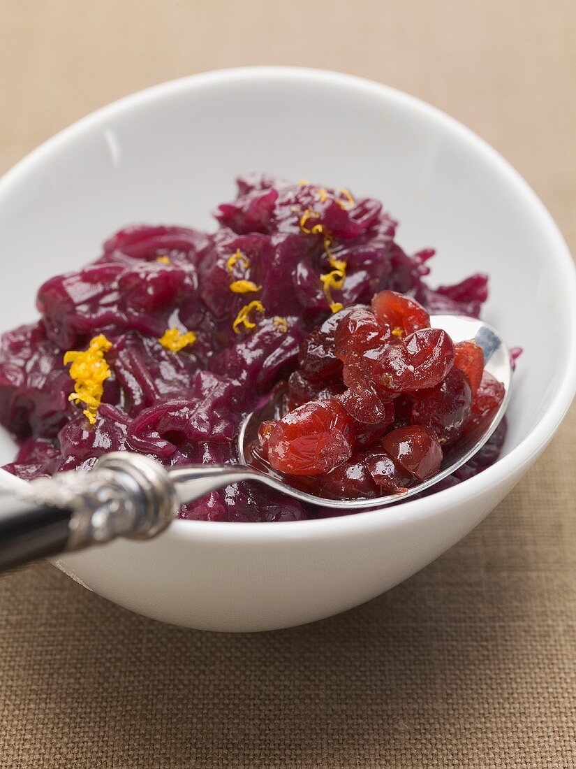 Red cabbage in bowl with spoonful of cranberries & orange zest