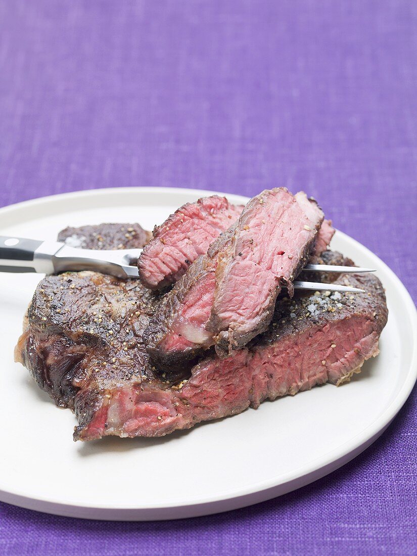 Beefsteak on plate with meat fork