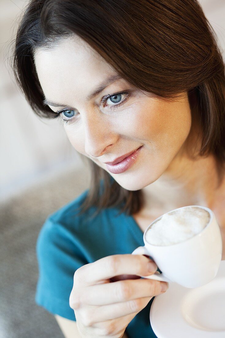 Woman drinking cappuccino