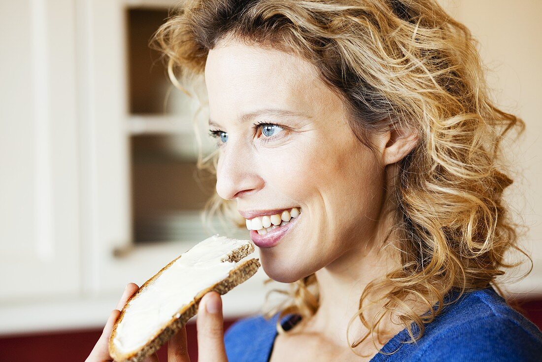 Woman eating bread and butter