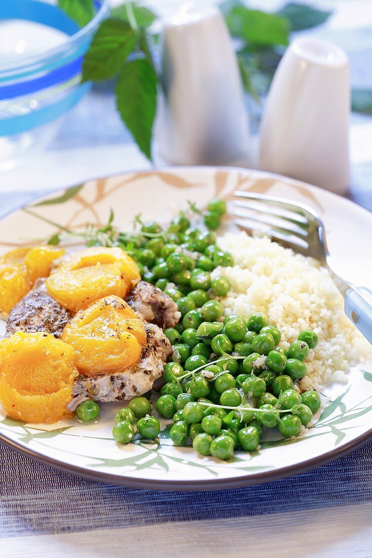 Pork chop with apricots, peas and rice