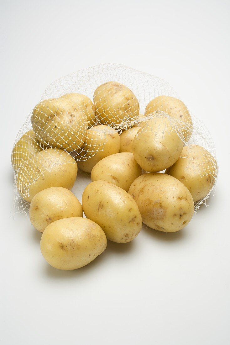 Potatoes in a net bag, torn open